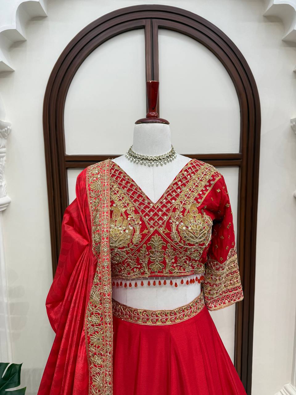 Regal Crimson Red Bridal Lehenga Choli Ensemble Featuring Intricate Gold Zari Embroidery, Heritage Motifs, and Embellished Tassels